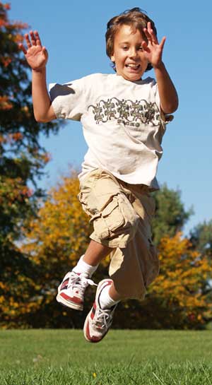 Images of a boy in a park jumping in the air